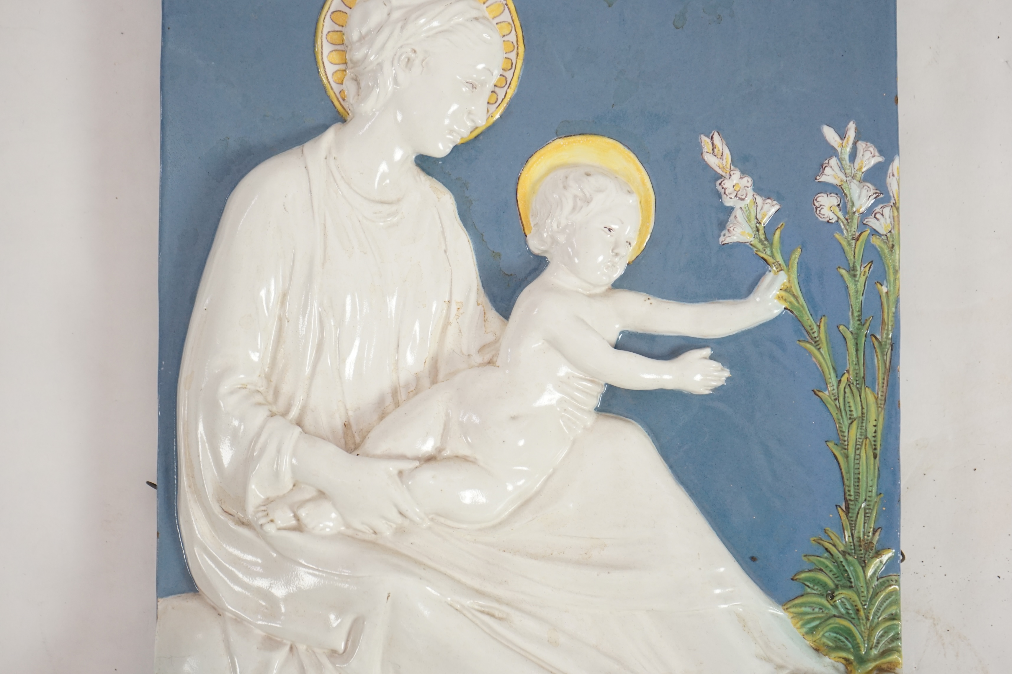 A Cantagalli maiolica wall plaque depicting the Virgin and child, 19th century, after Della Robbia